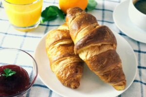 Top 10 Best Foods in the World You Must Try Tasty croissants served with orange juice and jam for a perfect breakfast.