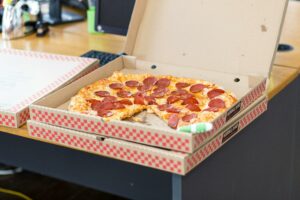 Top 10 Best Foods in the World You Must Try Delicious pepperoni pizza in an open box on a desk, perfect for a quick meal.